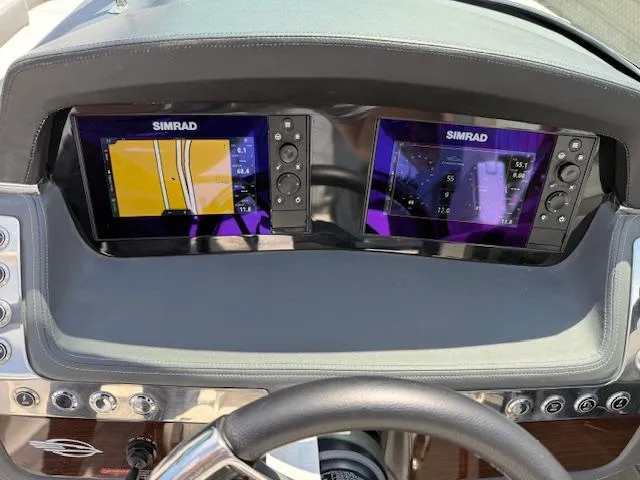Slide: The Image of Dashboard of 2023 Chaparral 267 SSX with dual Simrad navigation displays. - 19