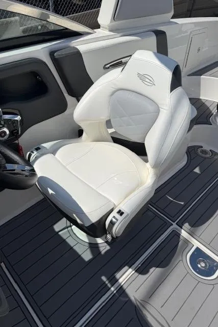Slide: The Image of 2023 Chaparral 267 SSX boat interior with luxurious white captain's chair and sleek design. - 22