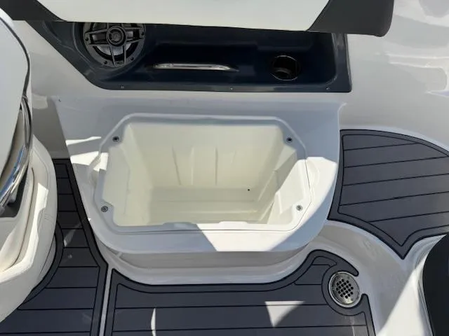 Slide: The Image of 2023 Chaparral 267 SSX boat deck with storage compartment and speaker. - 24