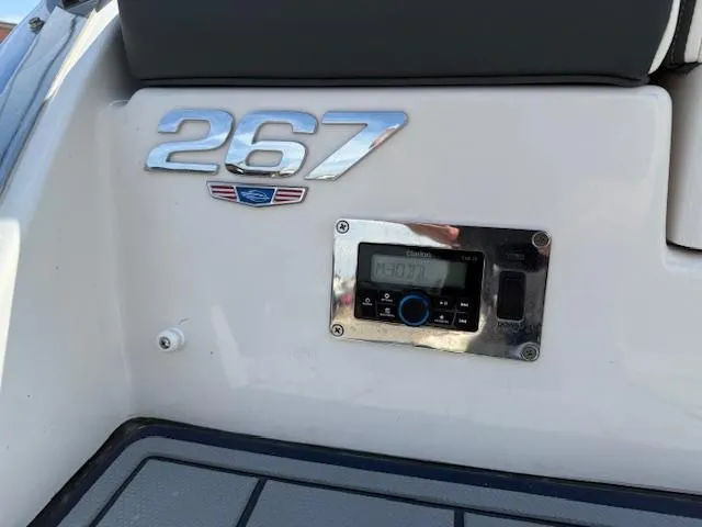 Slide: The Image of 2023 Chaparral 267 SSX boat dashboard with control panel and model emblem. - 31