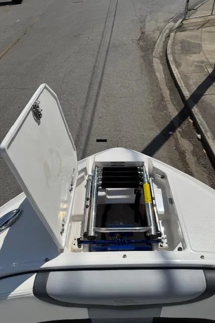 Slide: The Image of 2023 Chaparral 267 SSX boat with open bow storage compartment and ladder. - 7
