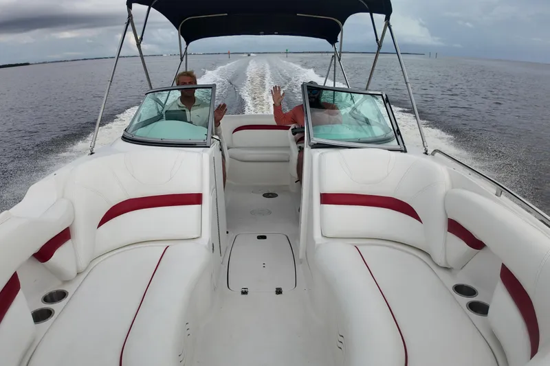 Slide: The Image of 2015 Hurricane SunDeck 2200 OB cruising on open water, featuring spacious seating and canopy. - 10