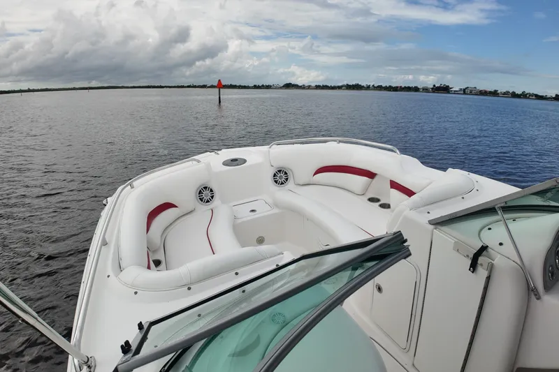 Slide: The Image of 2015 Hurricane SunDeck 2200 OB boat with spacious seating on a calm lake. - 12