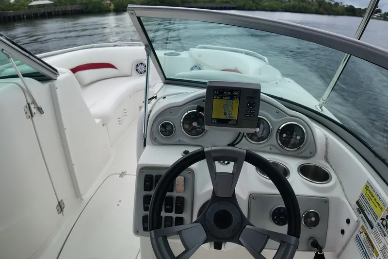 Slide: The Image of 2015 Hurricane SunDeck 2200 OB boat cockpit with steering wheel and navigation system. - 14