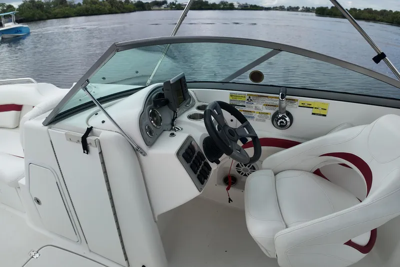 Slide: The Image of 2015 Hurricane SunDeck 2200 OB boat cockpit with steering wheel and controls. - 15