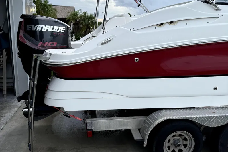 Slide: The Image of 2015 Hurricane SunDeck 2200 OB boat on trailer with Evinrude outboard motor. - 20