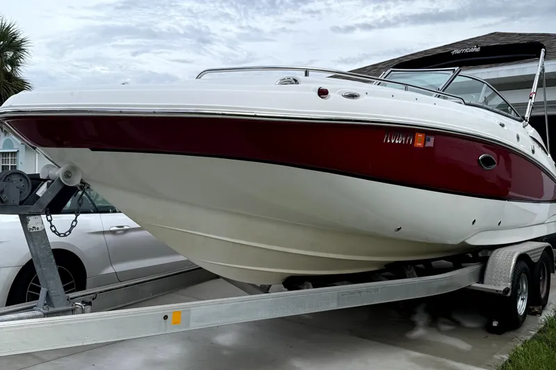 Slide: The Image of 2015 Hurricane SunDeck 2200 OB boat on trailer, parked outdoors. - 23