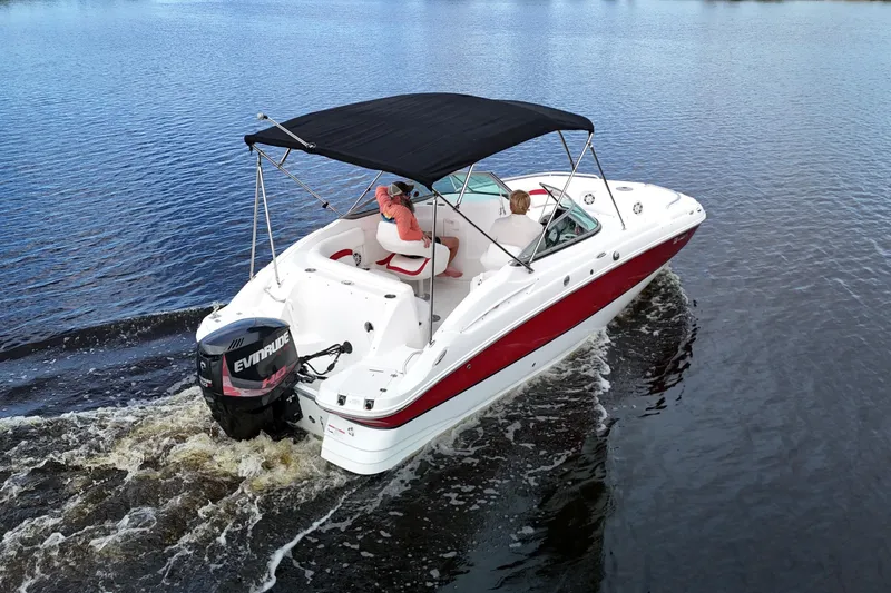 Slide: The Image of 2015 Hurricane SunDeck 2200 OB boat cruising on a calm lake with passengers. - 3