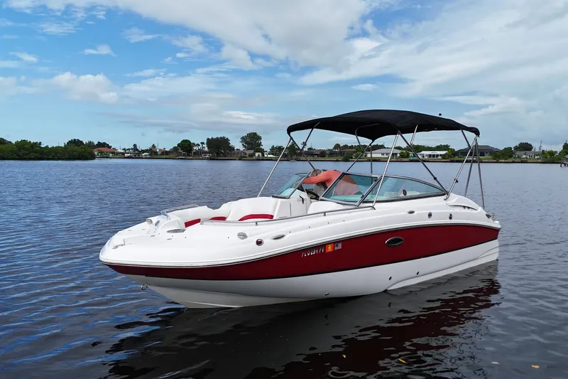 Slide: The Image of 2015 Hurricane SunDeck 2200 OB boat on calm water under a blue sky. - 5