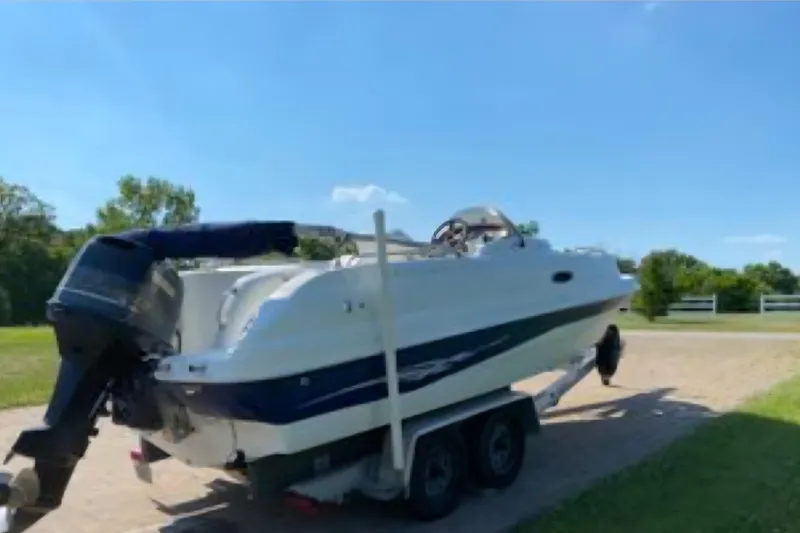 Slide: The Image of 2002 Starcraft AUORA 229 STEP CC DECK boat on trailer under clear blue sky. - 3