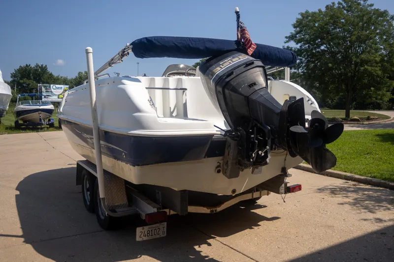 Slide: The Image of 2002 Starcraft AUORA 229 STEP CC DECK boat on trailer, parked outdoors. - 4