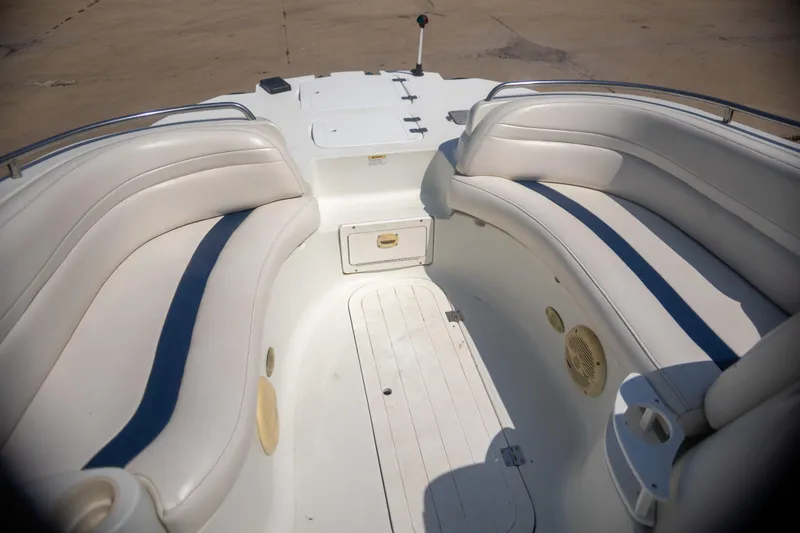 Slide: The Image of 2002 Starcraft AUORA 229 boat interior with white cushioned seating and storage compartments. - 9