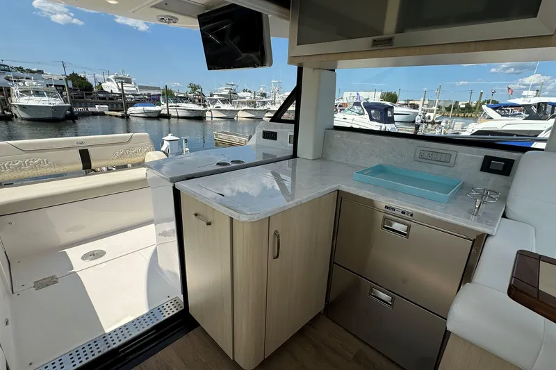 Slide: The Image of 2023 Regal 38 Grande Coupe yacht kitchen area with grill and control panel. - 10