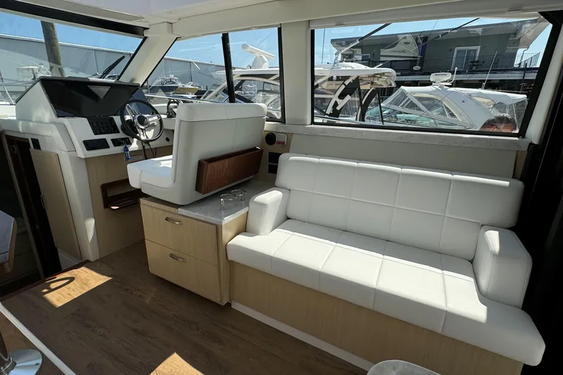 Slide: The Image of Interior of 2023 Regal 38 Grande Coupe with white seating and modern design. - 16