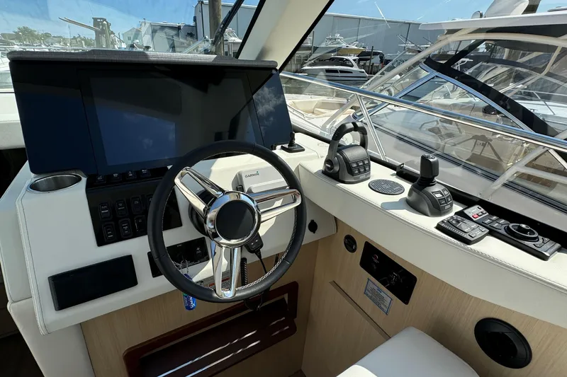 Slide: The Image of Captain's seat and helm of 2023 Regal 38 Grande Coupe yacht. - 19