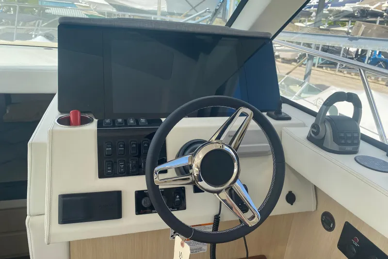 Slide: The Image of Helm of 2023 Regal 38 Grande Coupe with modern controls and navigation system. - 20
