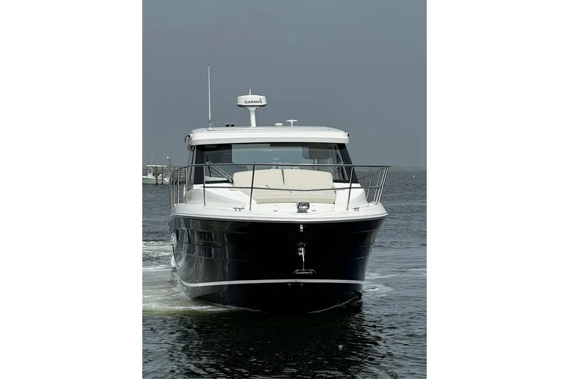 Slide: The Image of 2023 Regal 38 Grande Coupe yacht cruising on calm waters. - 3