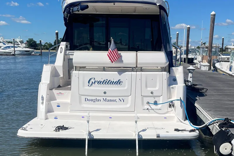 Slide: The Image of 2023 Regal 38 Grande Coupe yacht cruising on open water, front view. - 5