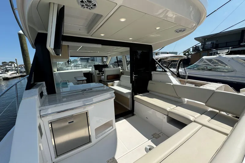 Slide: The Image of 2023 Regal 38 Grande Coupe docked, displaying "Gratitude" and American flag, Douglas Manor, NY. - 6