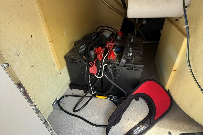 Slide: The Image of Battery compartment of a 2016 Sylvan Mirage Fish 8520 4-PT with visible wiring and accessories. - 11