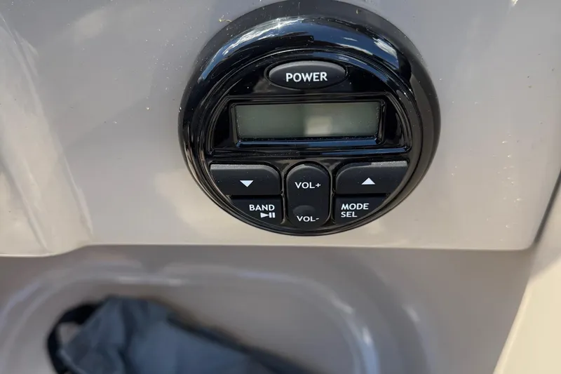 Slide: The Image of Control panel of a 2016 Sylvan Mirage Fish 8520 4-PT boat, featuring power and volume buttons. - 15