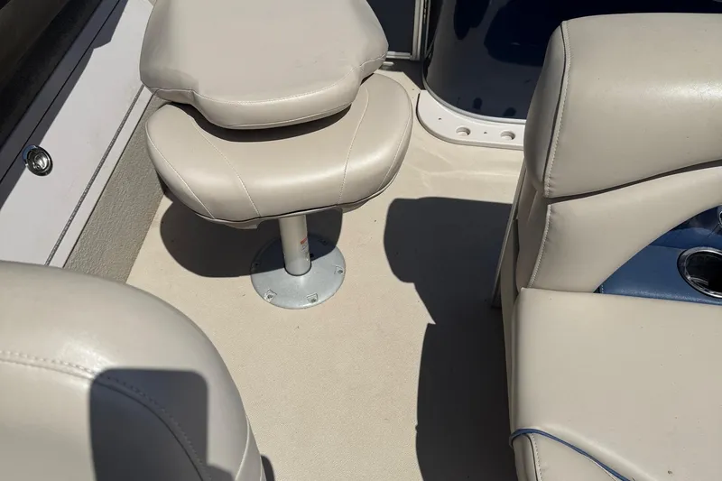 Slide: The Image of 2016 Sylvan Mirage Fish 8520 4-PT boat interior with beige seating and cup holder. - 17