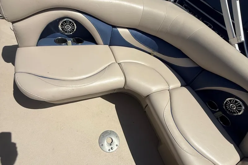 Slide: The Image of 2016 Sylvan Mirage Fish 8520 4-PT boat interior with beige and blue seating. - 18