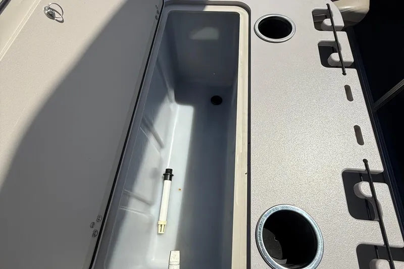 Slide: The Image of 2016 Sylvan Mirage Fish 8520 4-PT boat storage compartment with cup holders and rod holders. - 20