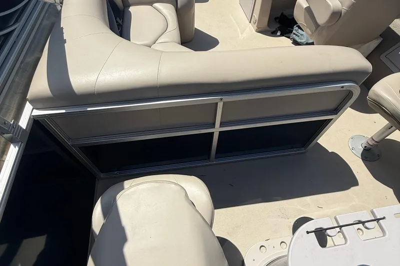 Slide: The Image of 2016 Sylvan Mirage Fish 8520 4-PT boat interior with beige seating and metal railing. - 21