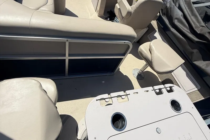 Slide: The Image of 2016 Sylvan Mirage Fish 8520 4-PT boat interior with beige seating and fishing station. - 22