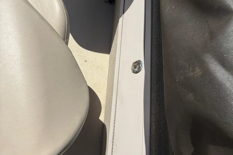 Slide: The Image of 2016 Sylvan Mirage Fish 8520 4-PT boat interior with beige seating and flooring. - 24