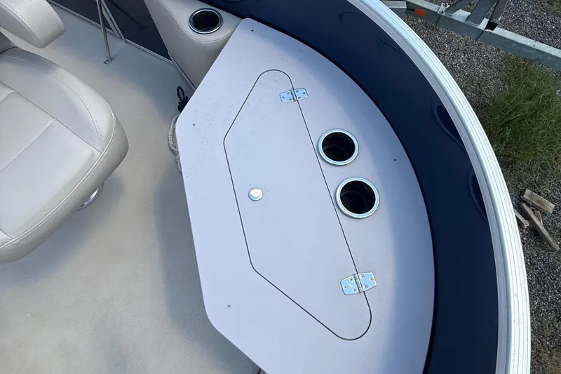 Slide: The Image of 2016 Sylvan Mirage Fish 8520 4-PT boat interior with seating and storage compartment. - 8