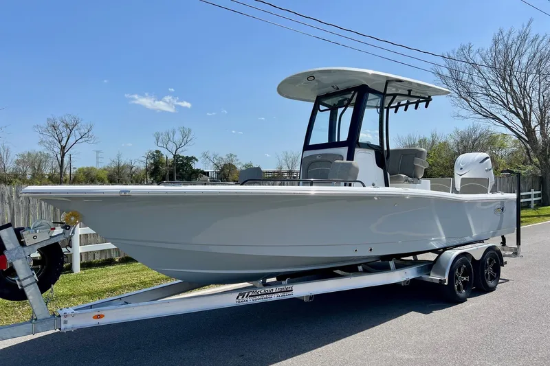 The Image of 2025 Sea Hunt BX 25 FS boat on trailer, parked outdoors under clear sky. - 1