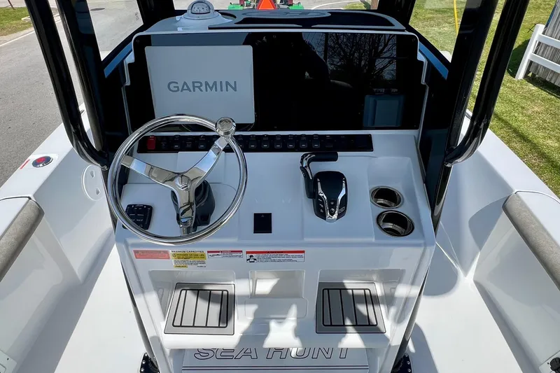 Slide: The Image of 2025 Sea Hunt BX 25 FS boat console with Garmin display and steering wheel. - 11