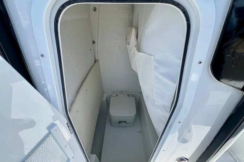 Slide: The Image of 2025 Sea Hunt BX 25 FS boat interior with compact marine toilet. - 14