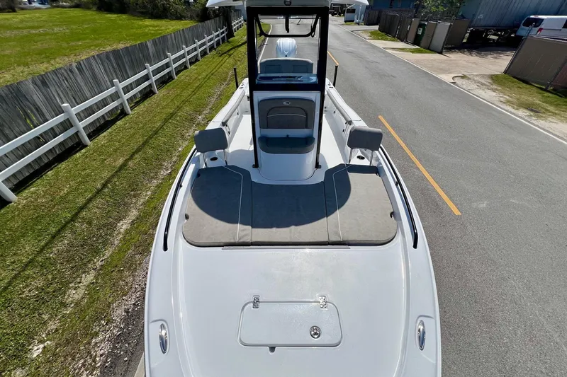 Slide: The Image of 2025 Sea Hunt BX 25 FS boat on road, top view, near fence and grass. - 18
