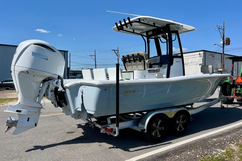 Slide: The Image of 2025 Sea Hunt BX 25 FS boat with Yamaha engine on trailer, parked outdoors. - 4
