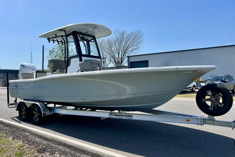 Slide: The Image of 2025 Sea Hunt BX 25 FS boat on trailer, parked outdoors under clear sky. - 5