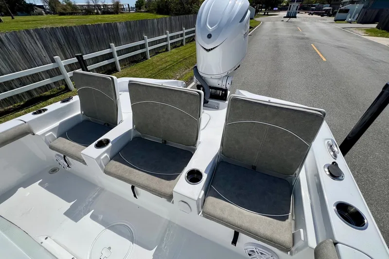 Slide: The Image of 2025 Sea Hunt BX 25 FS boat with three cushioned seats and outboard motor. - 7
