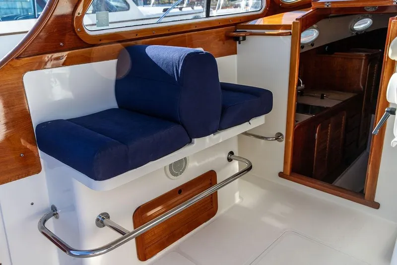 Slide: The Image of Interior of 2001 Hinckley Yachts Picnic Boat Classic 36 with blue cushioned seating. - 13