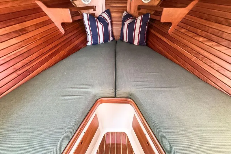 Slide: The Image of Interior of 2001 Hinckley Yachts Picnic Boat Classic 36 with cozy bedding and striped pillows. - 18