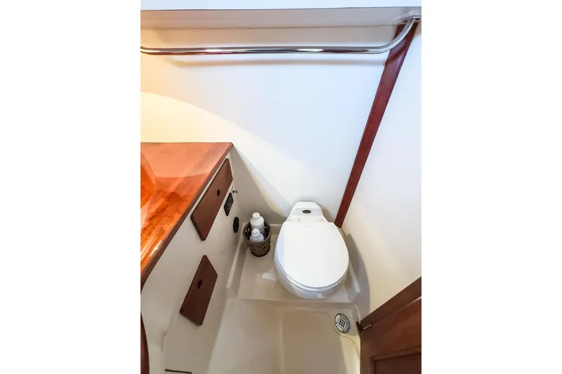 Slide: The Image of Hinckley Yachts 2001 Picnic Boat Classic 36 bathroom with wooden accents and modern fixtures. - 21