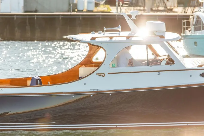 Slide: The Image of 2001 Hinckley Yachts Picnic Boat Classic 36 on sunlit water, showcasing elegant design. - 5
