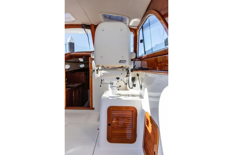 Slide: The Image of Interior of 2001 Hinckley Yachts Picnic Boat Classic 36, featuring helm seat and wooden accents. - 9