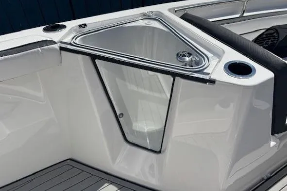 Slide: The Image of 2026 Yamaha Boats 255 FSH Sport H, sleek interior detail with storage compartment. - 15