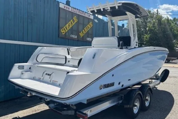 Slide: The Image of 2026 Yamaha Boats 255 FSH Sport H on trailer at Sizzle Marine dealership. - 2
