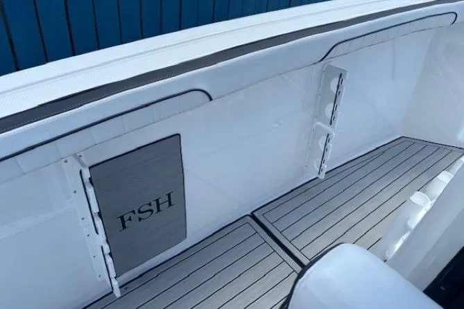Slide: The Image of 2026 Yamaha Boats 255 FSH Sport H interior with sleek white and gray design. - 20