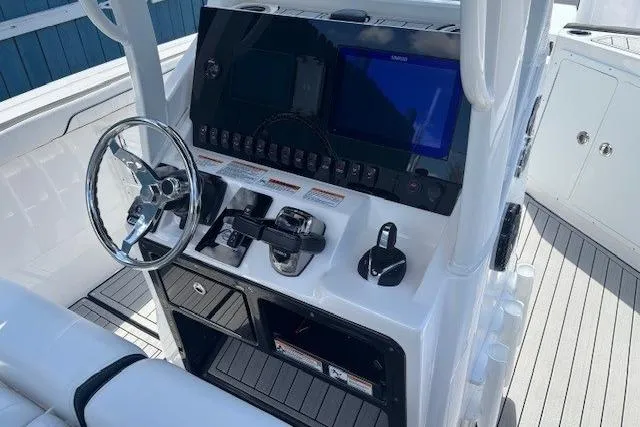 Slide: The Image of 2026 Yamaha Boats 255 FSH Sport H dashboard with steering wheel and controls. - 21