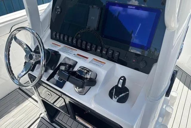 Slide: The Image of 2026 Yamaha Boats 255 FSH Sport H dashboard with steering wheel and control panel. - 23