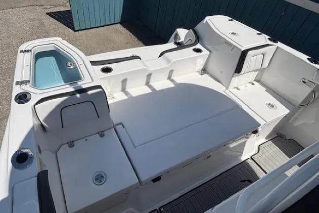 Slide: The Image of 2026 Yamaha Boats 255 FSH Sport H interior with seating and storage compartments. - 29
